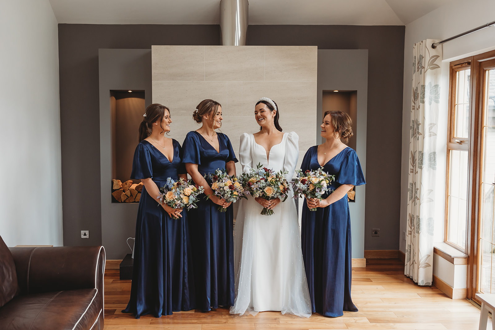 Bride standing with her bridesmaids in living room