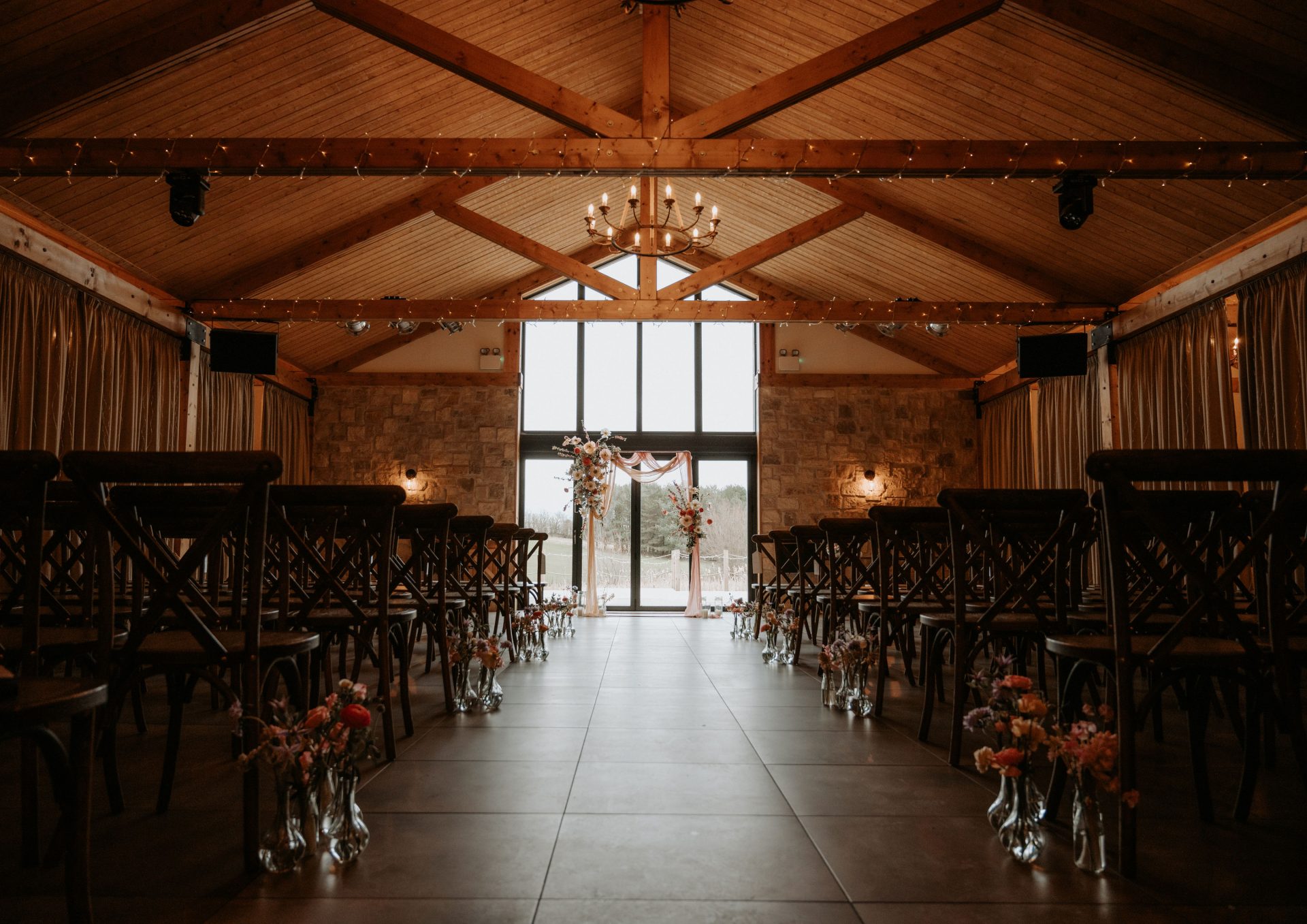 Ceremony hall with view of floor to ceiling window flower arch