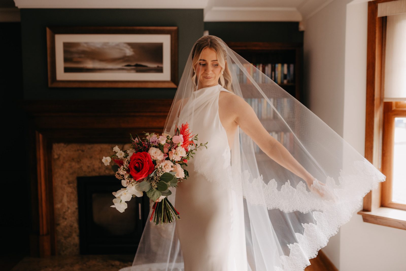 Bride with colourful flowers in living room setting